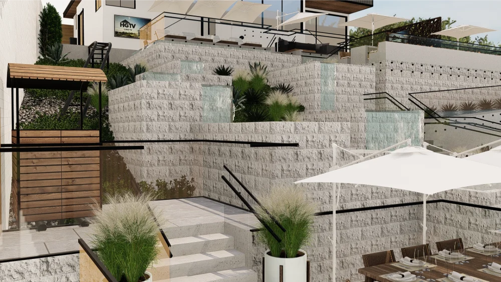 Multi-level outdoor patio designed for exceptional outdoor living with retaining walls, lush greenery, waterfalls, dining tables, and large white umbrellas under a clear sky.